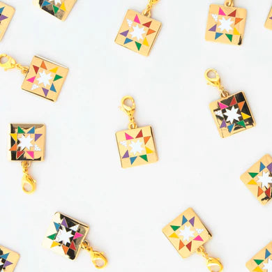 Add a pop of color to your bag, jacket, or charm bracelet with our Quilt Star Zipper Charm! This charming accessory features a colorful quilt star design and a convenient lobster clasp. Upgrade your style with ease!
