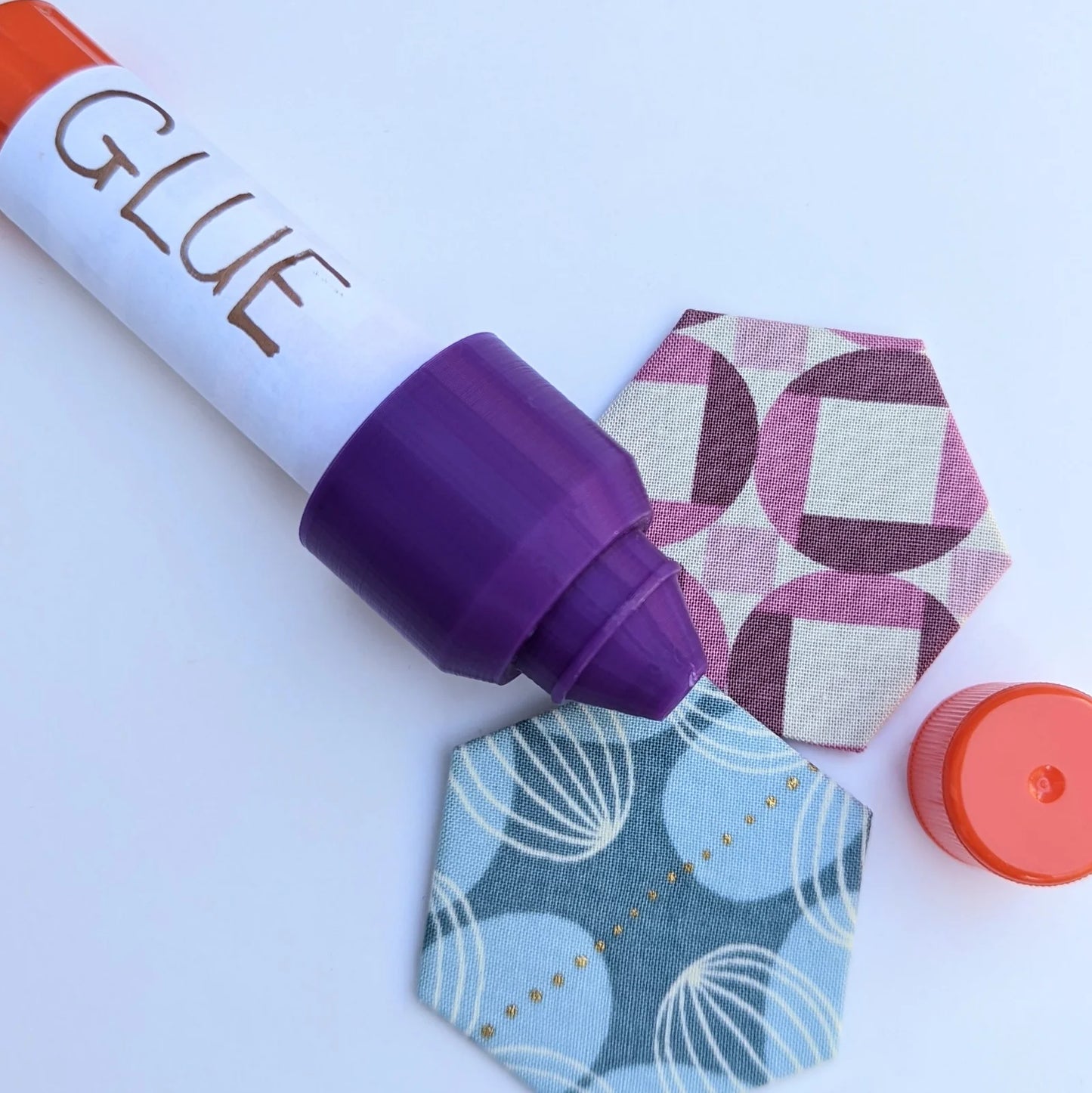 This reusable cap fits on a standard 6g washable craft glue stick. The soft glue is squeezed and shaped through the tip to a fine point, perfect for all your precision gluing jobs. Perfect for: English Paper Piecing, Foundation Paper Piecing, binding, and curves. When you're done, just pop the original cap right on the end for an airtight seal! Finished a glue stick and ready for a fresh one? Not a problem! Just pop the Glue Stick Precision Tip off the old stick and onto the new one!