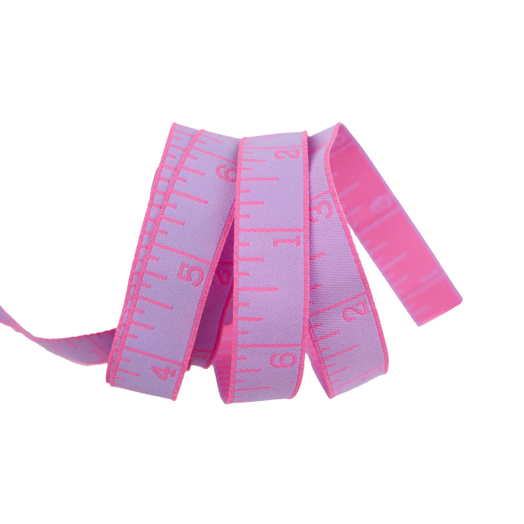 True Colors 2025 - Measure Twice in Bourgainvillea - 5/8" width - by Tula Pink
Introducing Measure Twice by designer Tula Pink! Each ribbon features a classic measuring tape design in a perfect 5/8" width, making it ideal for adding a touch of sewing charm to any project. With a rainbow of vibrant hues to choose from, these ribbons are both functional and fun—perfect for quilters, crafters, and sewing enthusiasts alike!