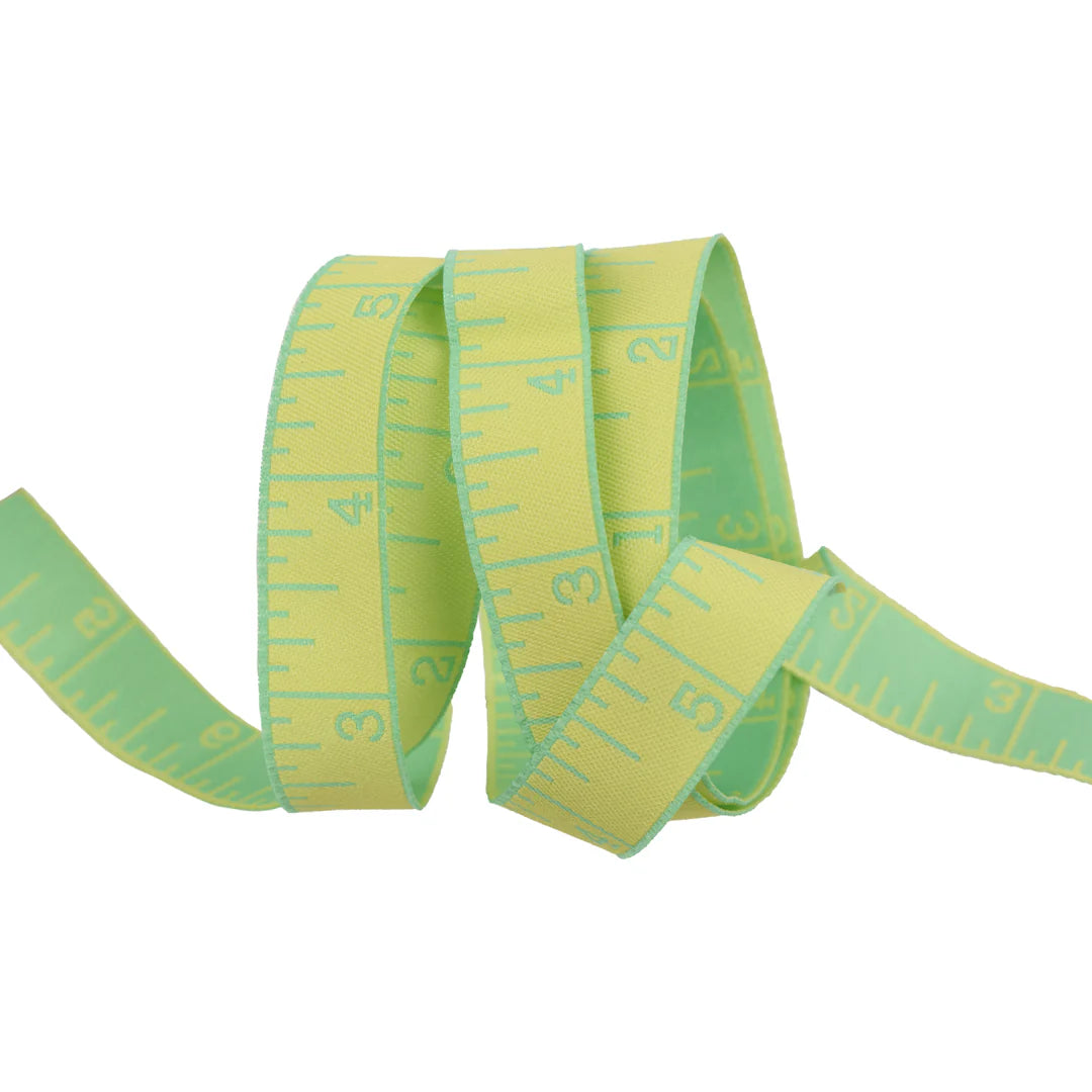 True Colors 2025 - Measure Twice in Lemon Zest - 5/8" width - by Tula Pink
Introducing Measure Twice by designer Tula Pink! Each ribbon features a classic measuring tape design in a perfect 5/8" width, making it ideal for adding a touch of sewing charm to any project. With a rainbow of vibrant hues to choose from, these ribbons are both functional and fun—perfect for quilters, crafters, and sewing enthusiasts alike!