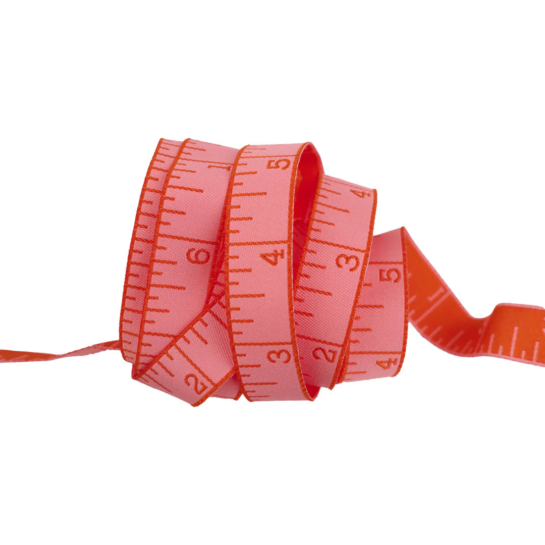 True Colors 2025 - Measure Twice in Peach Cobbler - 5/8" width - by Tula Pink
Introducing Measure Twice by designer Tula Pink! Each ribbon features a classic measuring tape design in a perfect 5/8" width, making it ideal for adding a touch of sewing charm to any project. With a rainbow of vibrant hues to choose from, these ribbons are both functional and fun—perfect for quilters, crafters, and sewing enthusiasts alike!