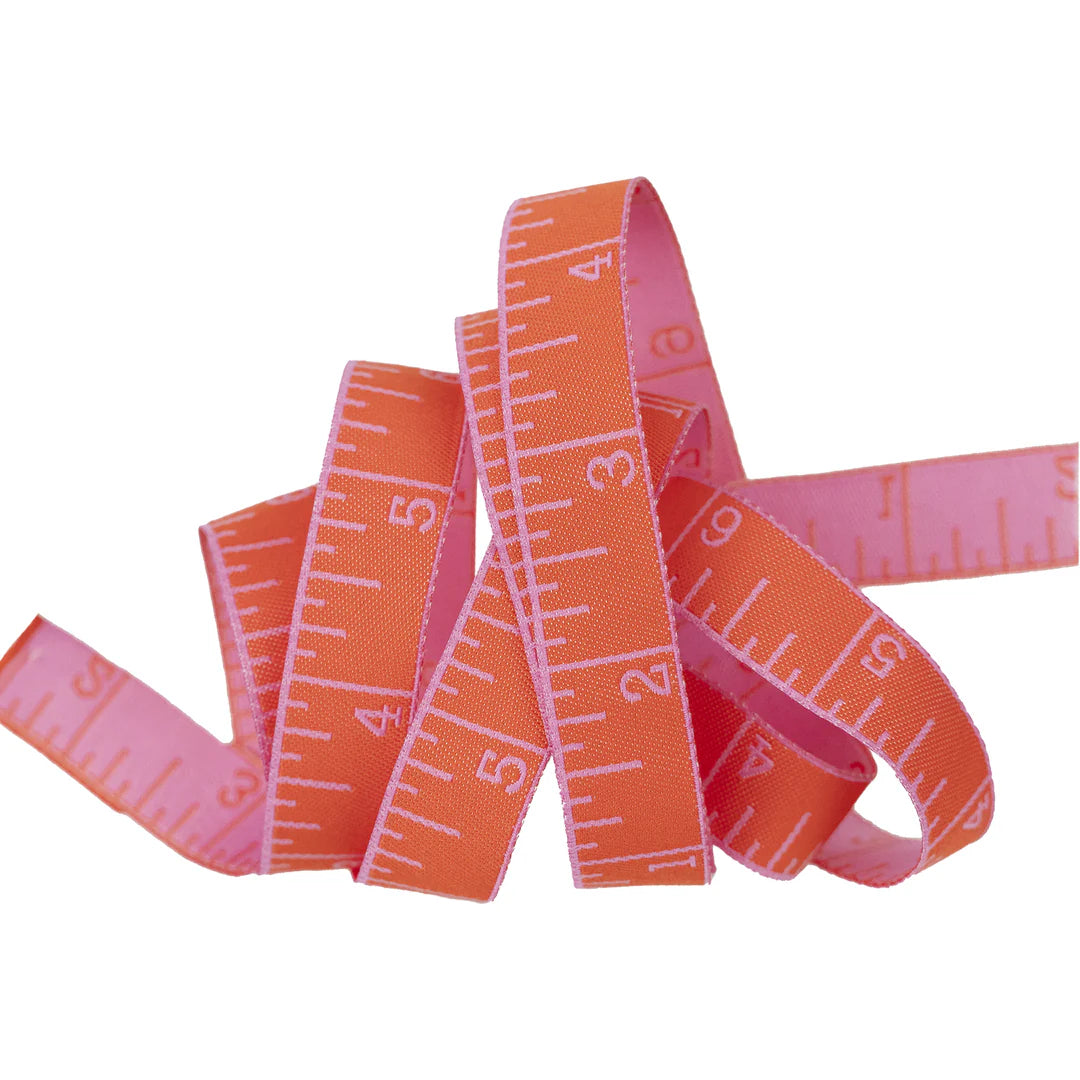 True Colors 2025 - Measure Twice in Sweet Tomato - 5/8" width - by Tula Pink
Introducing Measure Twice by designer Tula Pink! Each ribbon features a classic measuring tape design in a perfect 5/8" width, making it ideal for adding a touch of sewing charm to any project. With a rainbow of vibrant hues to choose from, these ribbons are both functional and fun—perfect for quilters, crafters, and sewing enthusiasts alike!