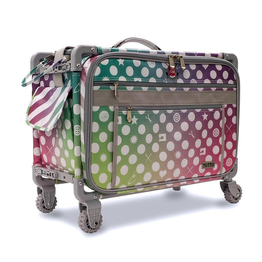 Exclusive Tula Pink innovative transportation system from Tutto.  On the exterior, the Tula Pink signature rainbow shimmer print coordinates with Tula's 570 QE Bernina sewing machine.  Manufactured from balistic nylon and features a fiberglass frame.   21"L x 13.25"H x 12".  Folds to 3in for storage.  Top access 17" L x 8.25"D or side load. Stacks up to 150 lbs and weighs only 11 lbs empty. Fits all 5 Series Bernina Machines.