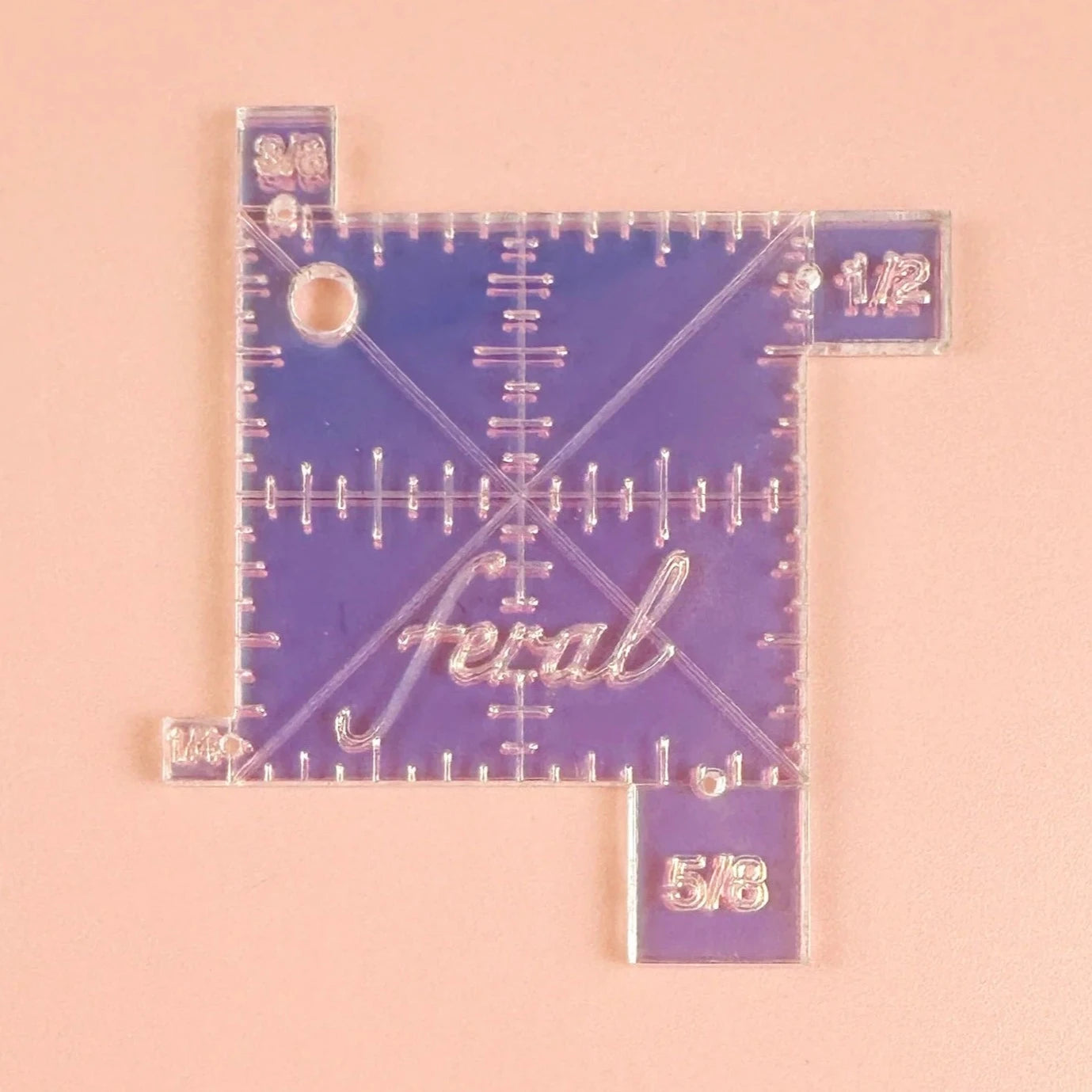 Stop guessing! Take the uncertainty out of seam allowances with our handy dandy seam gauge. Durable and beautiful laser cut iridescent acrylic. All markings are laser engraved so they'll never rub off! 1/8" thick acrylic. Features gauges for seam allowances of 1/4", 3/8", 1/2", and 5/8". Holes for your machine's needle for accurate allowance marking. 2" square with diagonal 45 degree markings