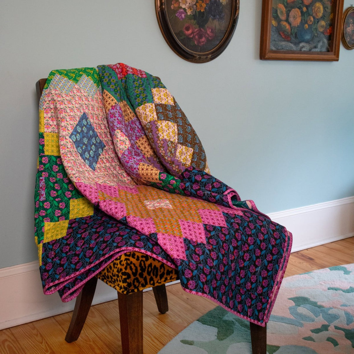The Heiress Quilt was designed to evoke some of the geometry and charming patterns present in the many traditional handcrafts. In one moment, the shapes seem to take on the form of a woven kilim but at the same time it shares the features of a bold needlework - but of course it's a quilt! The clever arrangement of blocks allows the quilter to repeat very simple color combinations and then flip the orientation for a pleasing layout.

**This is the pattern only.

-Finished Size: 75" x 90"