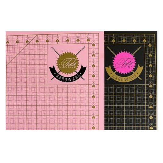 The Tula Pink Double Sided Cutting Mat 24in X 18in is a premium self-healing cutting mat featuring: 2 colored sides Pink and Black with Gold markings, left and right hand friendly, and has a 45degree angle marking.