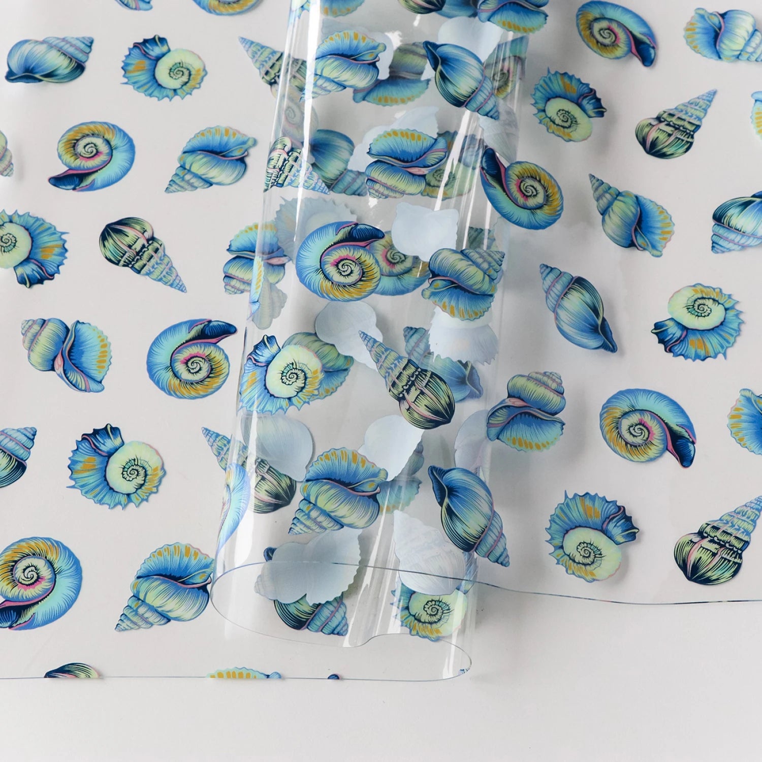Bring a splash of underwater magic to your sewing projects with Tula Pink’s Floral Reef Collection. Each design is printed on durable, easy-to-clean TPU vinyl that’s perfect for bags, accessories, and home décor.

Lil’ Shelly: Sweet and charming seashell motifs that bring a coastal vibe to your designs.

Size: 25" width and .45mm thick