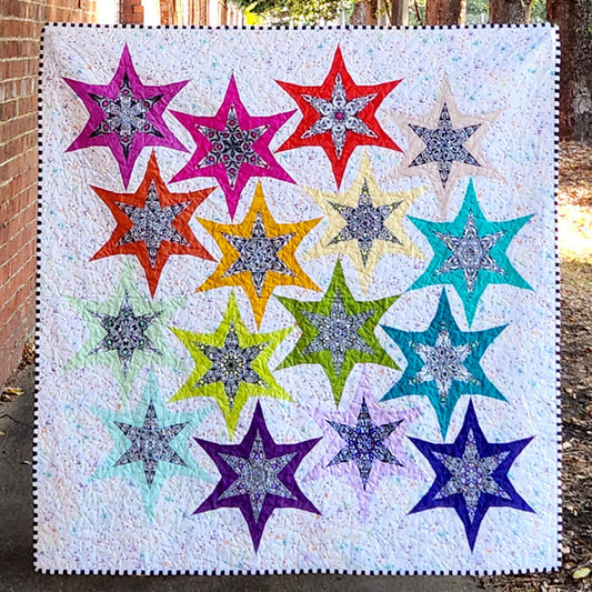 Welcome to “Frenzy”, a quilt that will take you on a fun journey of self-expression through the wonderful world of fussy cutting with sixteen (16) blocks to play with. 