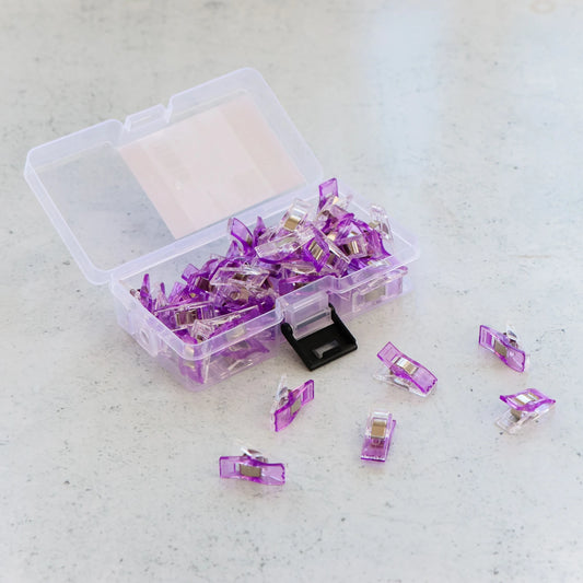 These Sallie Tomato Purple sewing clips are a must-have notion for your sewing room! They are a great alternative for pins - unlike pins, these sewing clips won't prick you as you work or leave holes in your fabric. And their flat backs allow you to feed fabric under the foot of a sewing machine without hindrance.
