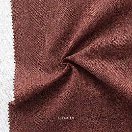 Manufacturer: Fableism Supply Co. Designer: Fableism Supply Co. Collection: Everyday Chambray: Nocturne Print Name: Garnet Material: 52% Cotton/48% Bamboo SKU: ECW-NOC-01-GARNET Width: 44 inches