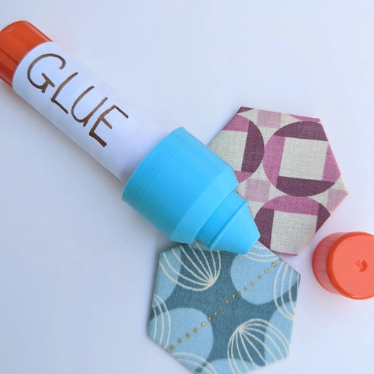 This reusable cap fits on a standard 6g washable craft glue stick. The soft glue is squeezed and shaped through the tip to a fine point, perfect for all your precision gluing jobs. Perfect for: English Paper Piecing, Foundation Paper Piecing, binding, and curves.  When you're done, just pop the original cap right on the end for an airtight seal! Finished a glue stick and ready for a fresh one? Not a problem! Just pop the Glue Stick Precision Tip off the old stick and onto the new one! 